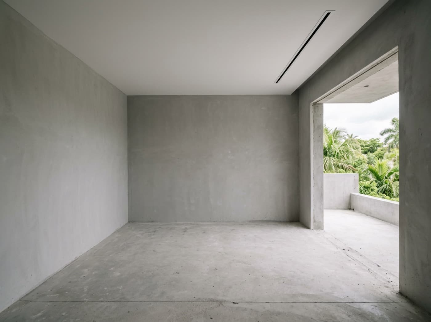 Concept visualization: an empty room in shell condition with bare plaster walls and a structural opening onto a terrace